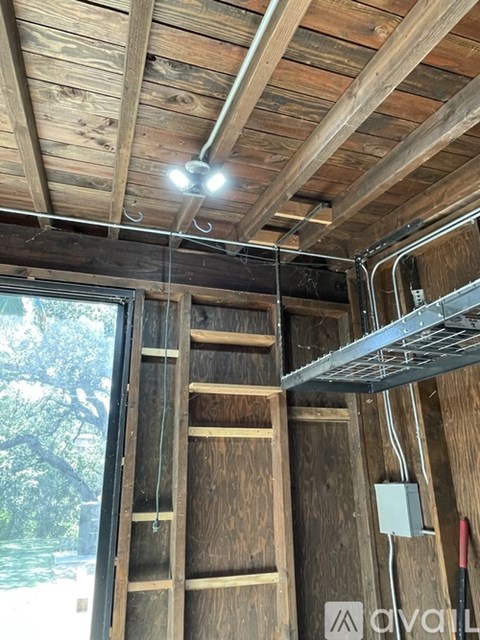 A wooden ladder is leaning against a wall in a room under construction.