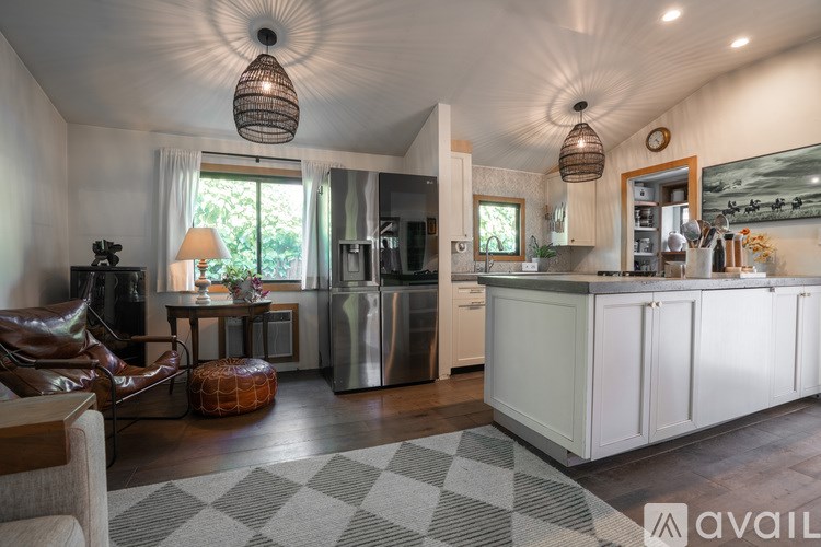 A modern kitchen with white cabinets and a large island.