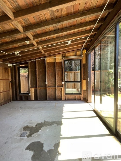 A room under construction with wooden walls and ceiling.