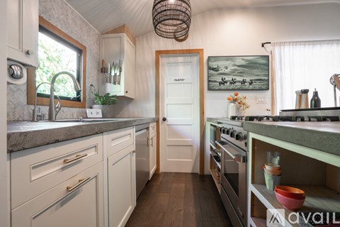 A kitchen with a sink, stove, and oven.