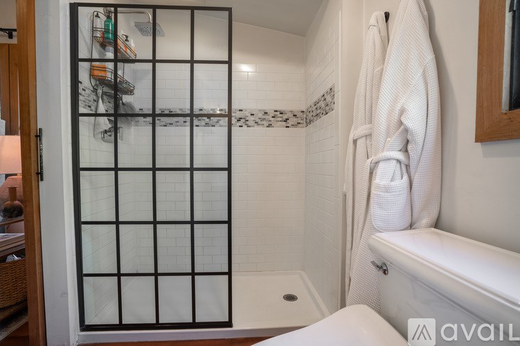A white towel is hanging on a towel rack in a bathroom.