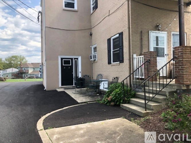 A house with a black door and a small patio area.