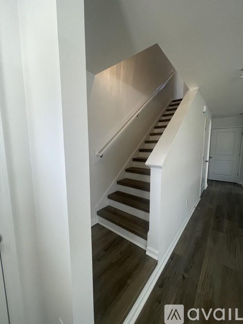 A staircase with a white railing and wooden steps.