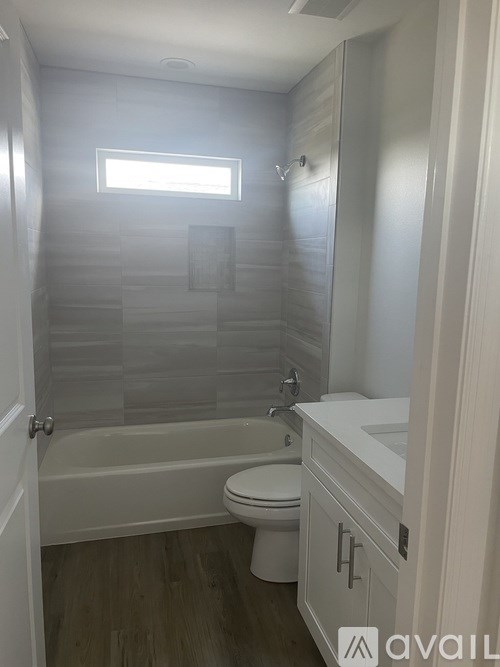 A bathroom with a toilet, sink, and tub.