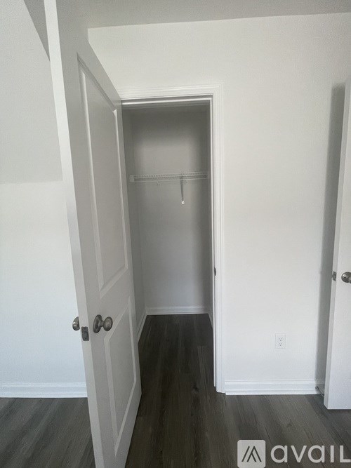 A hallway with a door at the end.
