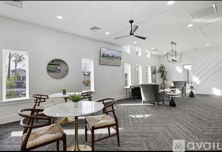 A spacious living room with a dining table and chairs.