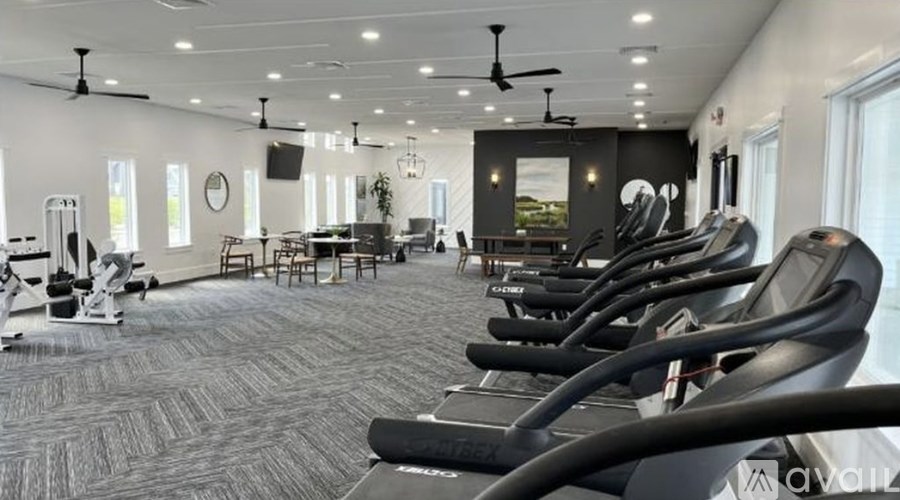 A gym with treadmills and other exercise equipment.