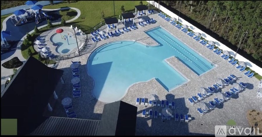 An outdoor swimming pool surrounded by sun loungers.