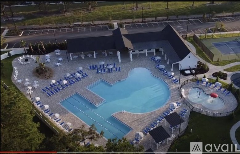 An outdoor swimming pool surrounded by sun loungers.