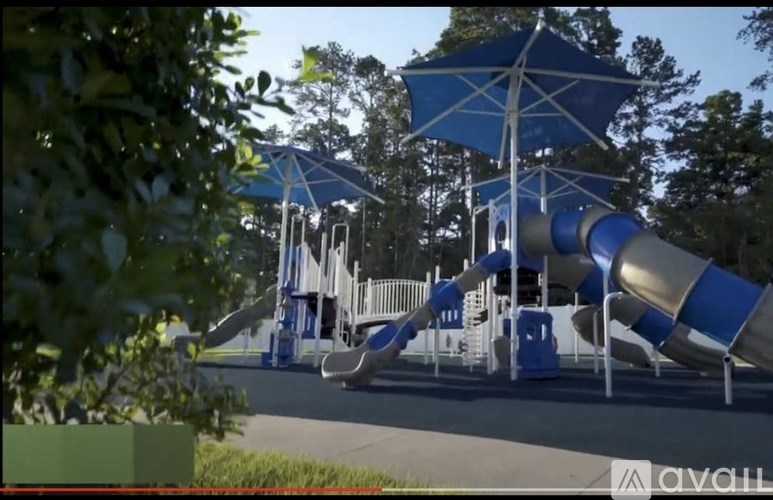 A playground with a blue and white slide.