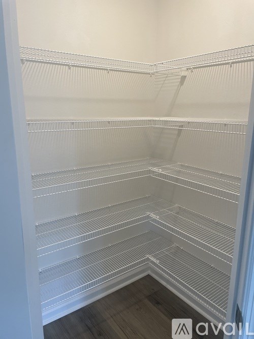 Empty white shelves in a room.