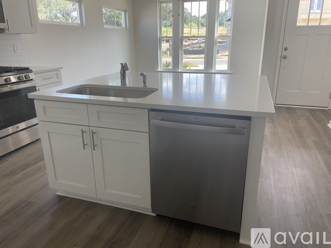 A kitchen with a sink and a dishwasher.