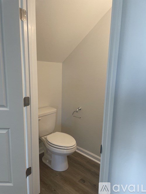 A white toilet in a small bathroom.
