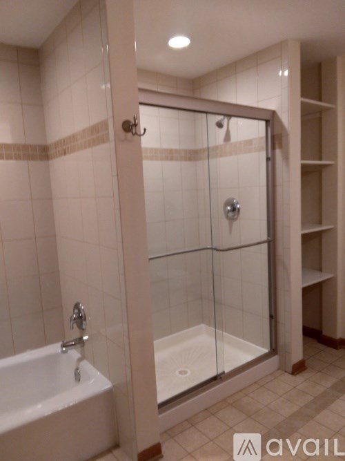 A bathroom with a white tub and a walk in shower.