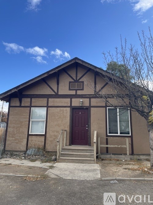 A small house with a brown door and a brown roof.
