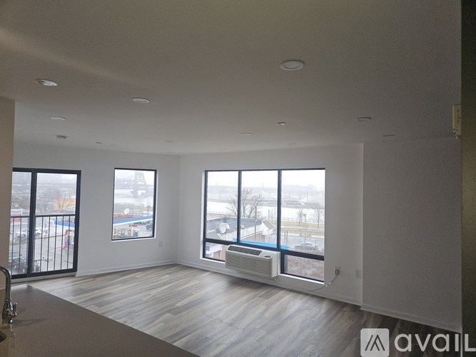 A spacious living room with a view of the outdoors through large windows.