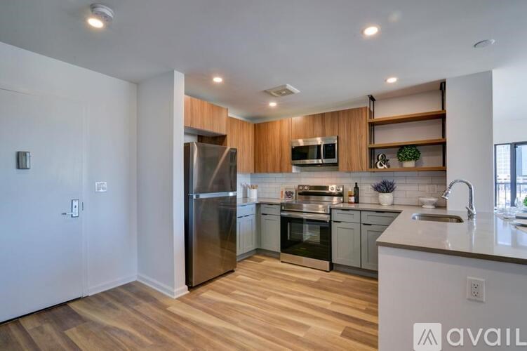 A modern kitchen with wooden cabinets and stainless steel appliances.