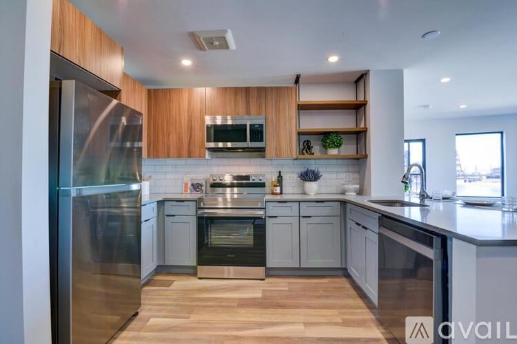 A modern kitchen with wooden cabinets and stainless steel appliances.