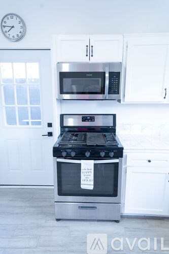 A modern kitchen with a stove and microwave.