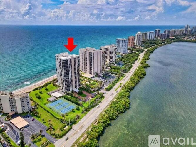 A red arrow points to a building in a beachfront city.