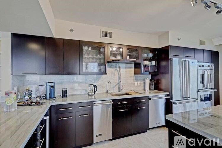 A kitchen with dark brown cabinets and stainless steel appliances.