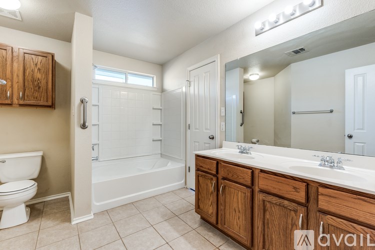 A bathroom with a toilet, sink, and bathtub.