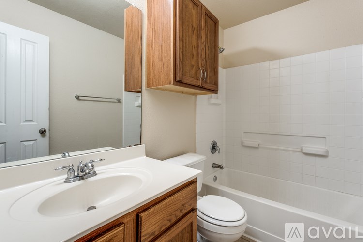 A bathroom with a white sink, toilet, and bathtub.