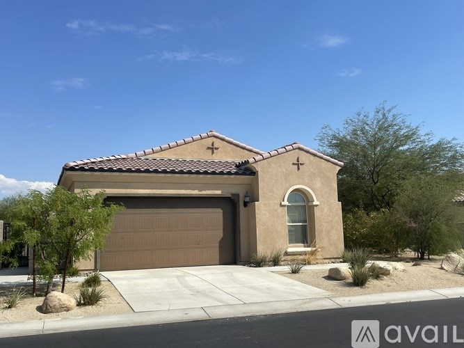 A house with a brown garage door and a cross on the wall.