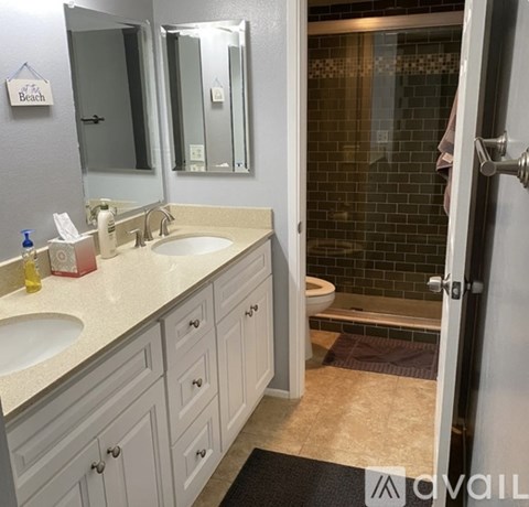 A bathroom with a sink, mirror, and toilet.