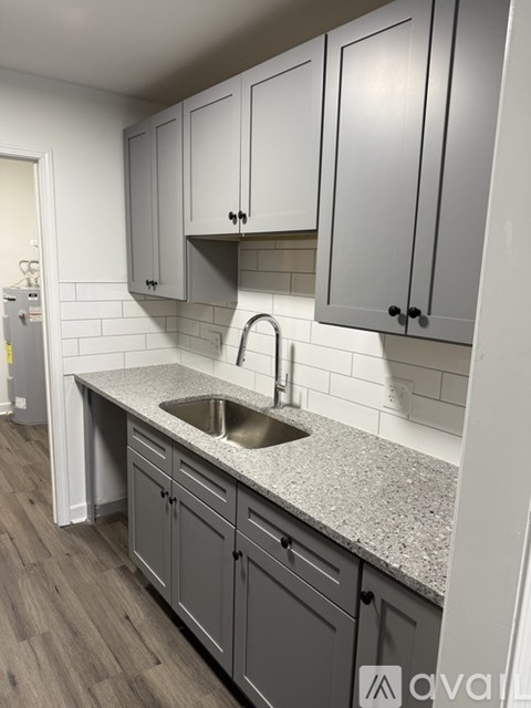 A kitchen with a sink and cabinets.