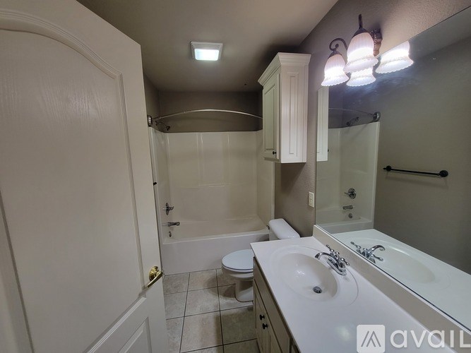 A bathroom with a white sink, toilet, and bathtub.