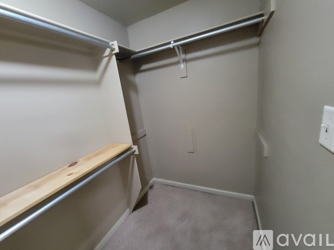 A small, empty room with a single shelf and a door.