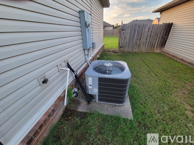 A house with a wall-mounted air conditioning unit outside.