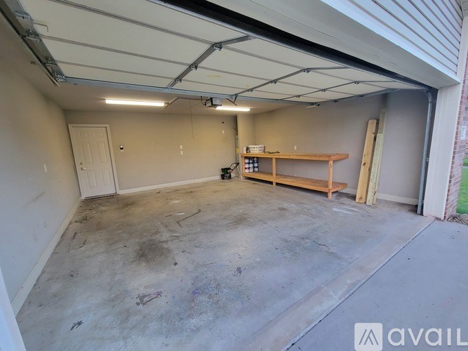 A garage with a workbench and a door.