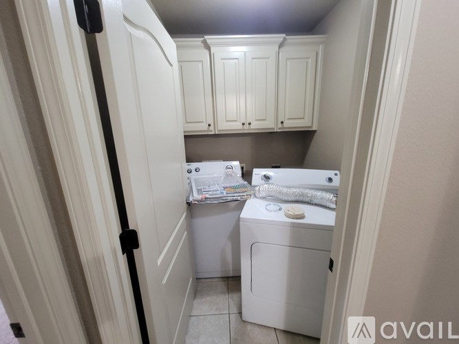 A small laundry room with a washer and dryer.