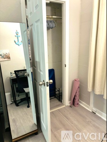 A room with a desk and a chair is visible through an open door.