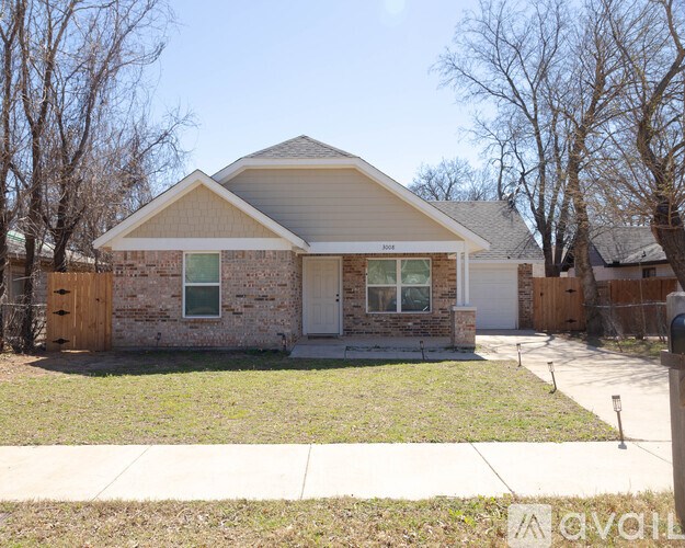 A house with a brick facade and a white garage door.