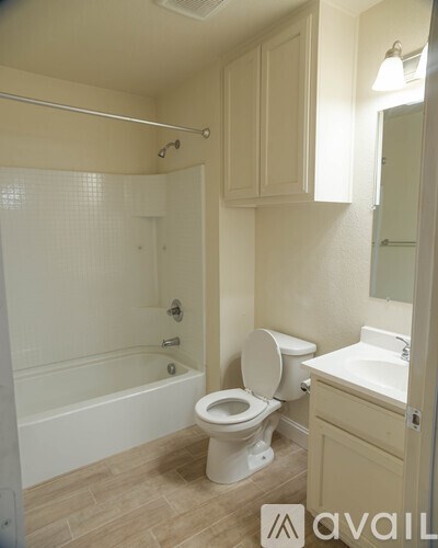 A bathroom with a toilet, sink, and bathtub.