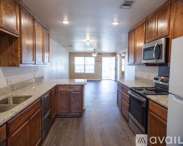 A kitchen with wooden cabinets and a white refrigerator.