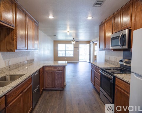 A kitchen with wooden cabinets and a white refrigerator.