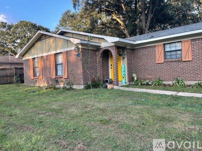 A house with a yellow door and a sign that says "available" in front of it.