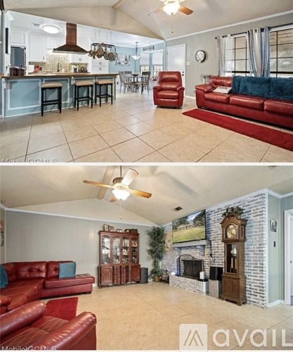 A living room with a fireplace and a kitchen area.
