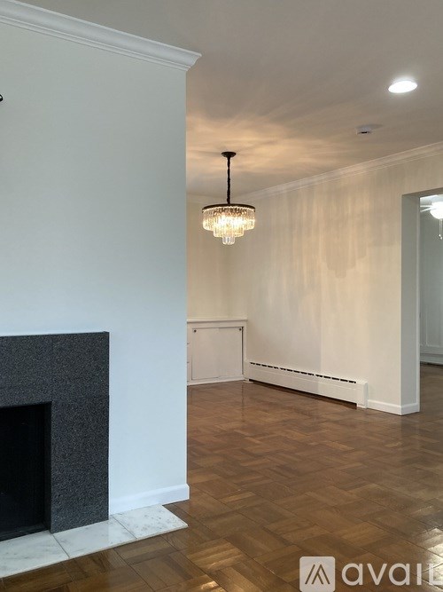 A room with a fireplace and a chandelier.