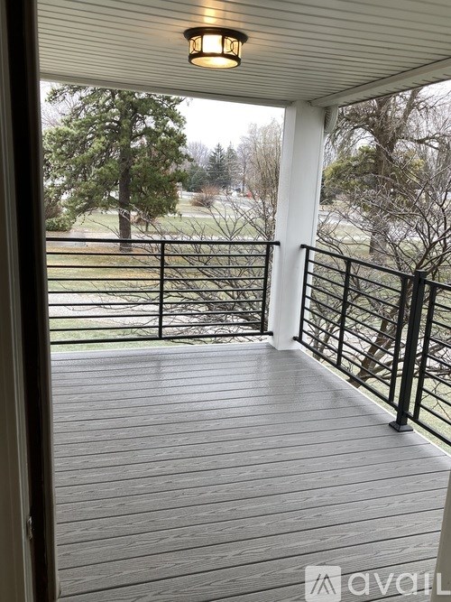A deck with a railing and a light on it.