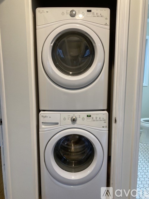 A white washing machine and dryer stacked on top of each other.