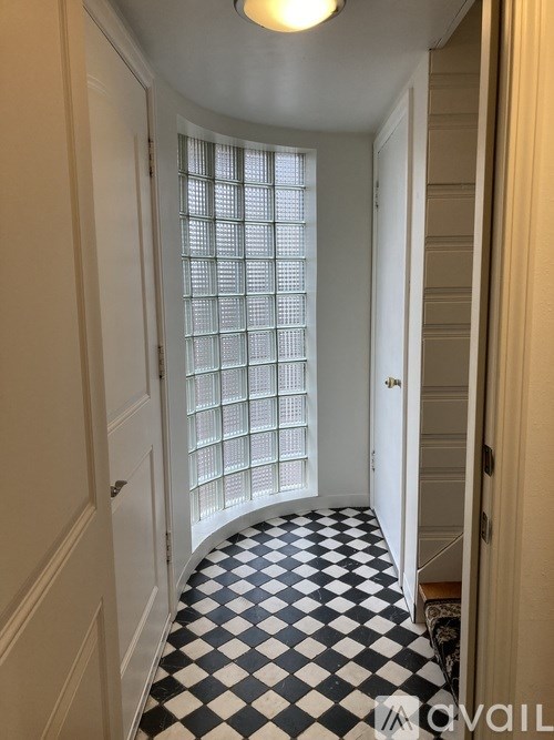 A hallway with a checkered black and white floor.