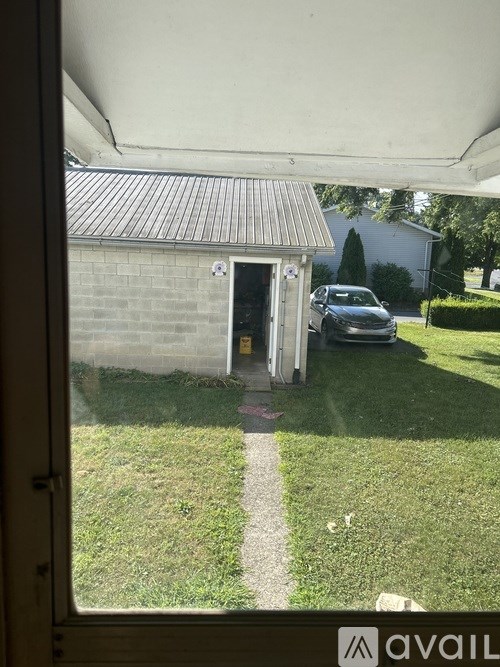 A car is parked in a driveway outside a house.