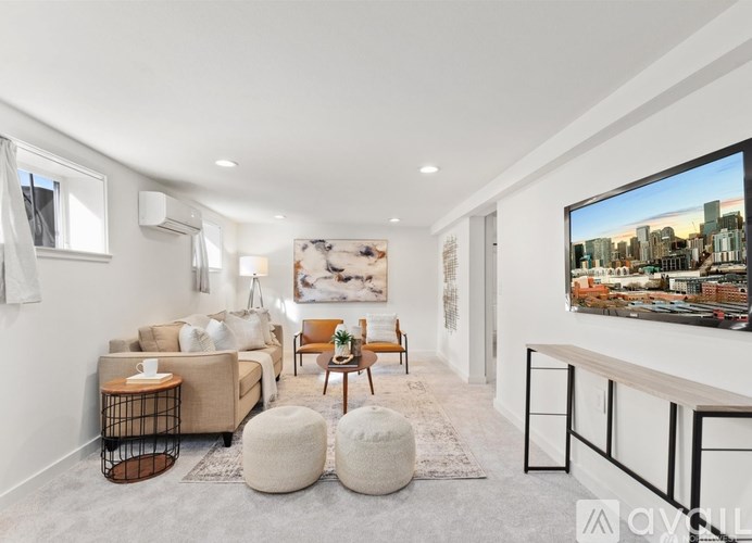 A modern living room with a large TV and a cityscape on the screen.