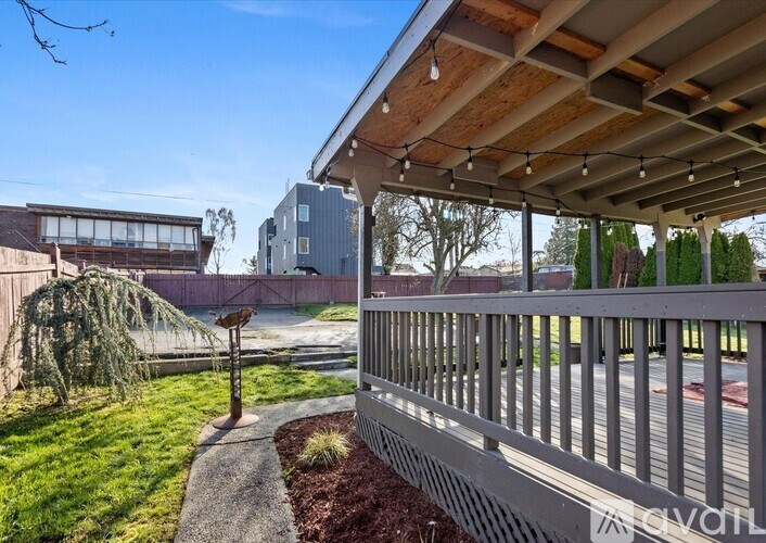 A patio with a metal railing and a wooden roof.