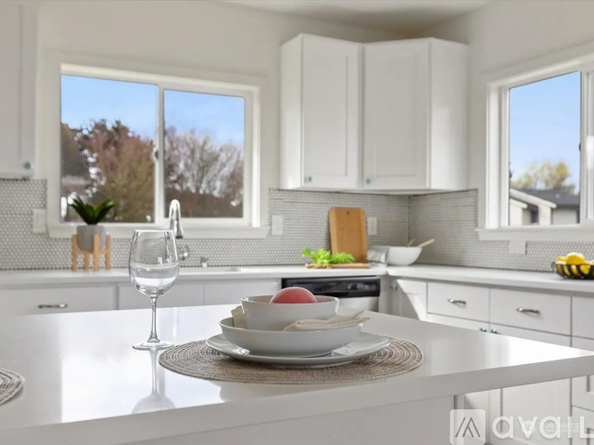 A dining room with a table and chairs and a view of the outside.